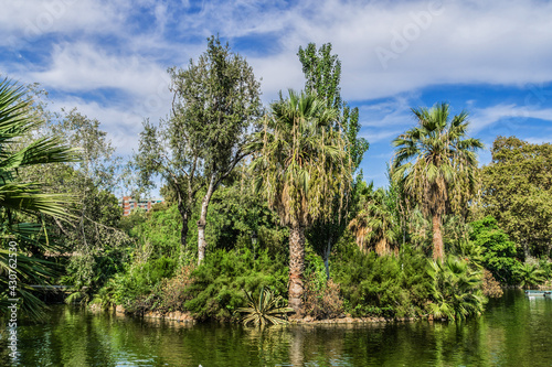 Small lake in Park de la Ciutadella - popular spot where you can hire a rowing boat. Park de la Ciutadella - thirty-hectare large park close to always crowded historic center of Barcelona. Spain. © dbrnjhrj