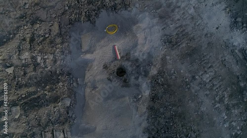 Top down aerial drone view of Opening for explosives in a quarry. There are explosives next to the well. Preparation of an explosion at the quarry site.

