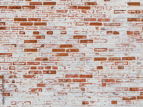 texture: old cracked brick wall painted in white paint