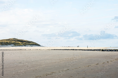 people walking on the sandy beach and dunes of the Wadden Island of Vlieland