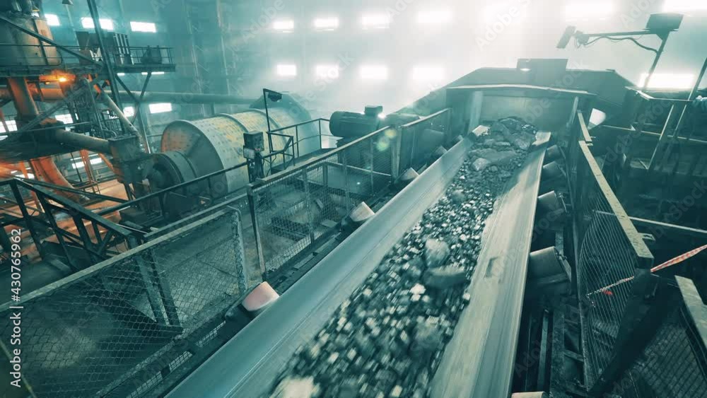 Transportation of copper ore carried out in the factory. Mining industrial conveyor at ore processing factory.
