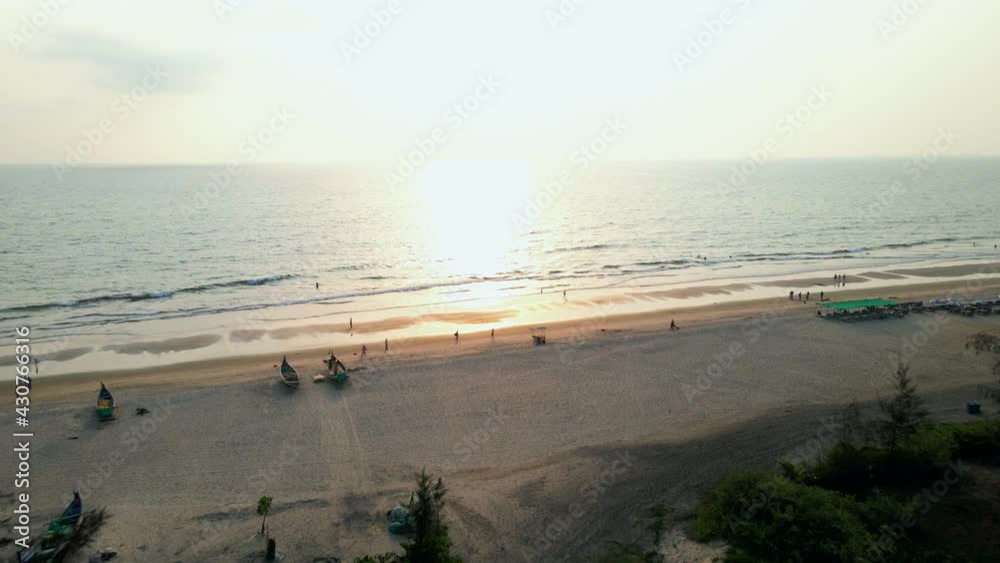arambol goa beach drone shot ships boats on empty beach birds-eye view sunset. arambol goa beach drone shot ships boats on empty beach birds-eye view sunset.