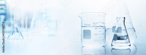flask with clear beaker and glassware in medical science lab banner background