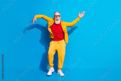 Full size photo of funky funny handsome mature man dancing make silly moves isolated on blue color background