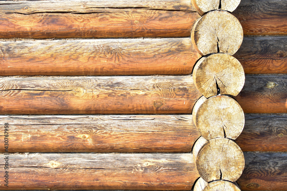 Texture of wall of house made of rounded logs. facade of log house, space for text. Wooden log wall built from smoothly polished logs. Construction of houses from natural materials. Wooden frame Texture of wall of house made of rounded logs. facade of log house, space for text. Wooden log wall built from smoothly polished logs. Construction of houses from natural materials. Wooden frame
