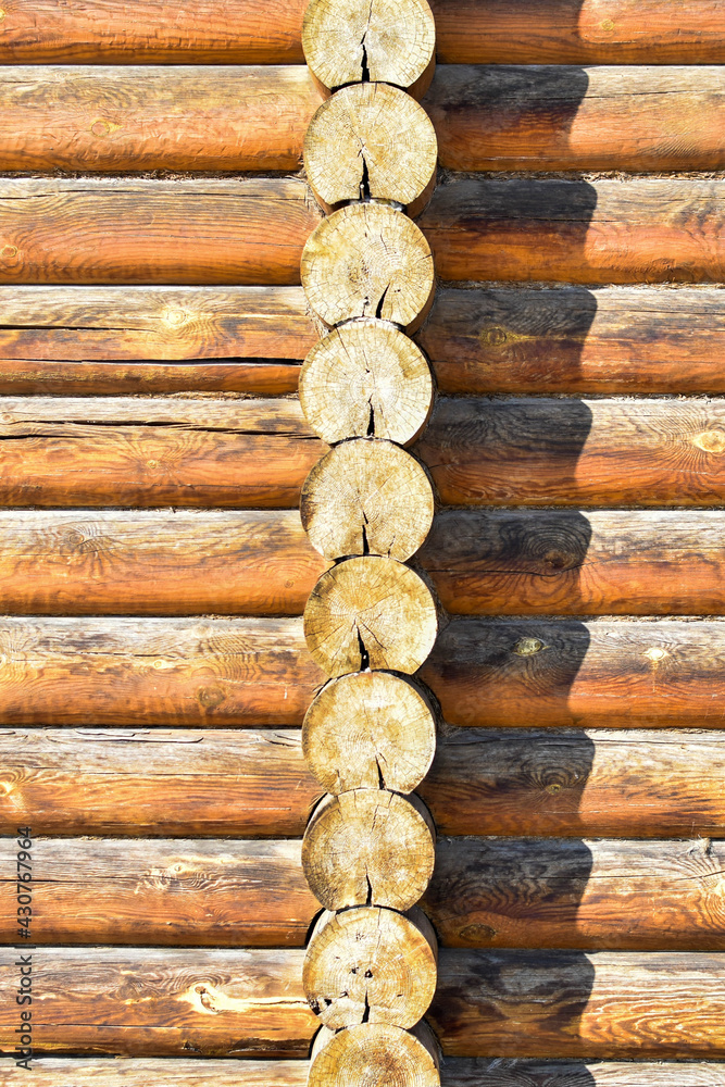 Texture of wall of house made of rounded logs. facade of log house, space for text. Wooden log wall built from smoothly polished logs. Construction of houses from natural materials. Wooden frame Texture of wall of house made of rounded logs. facade of log house, space for text. Wooden log wall built from smoothly polished logs. Construction of houses from natural materials. Wooden frame