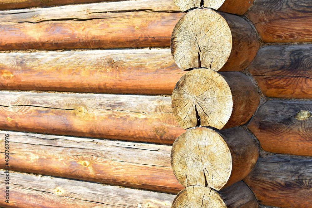 Texture of wall of house made of rounded logs. facade of log house, space for text. Wooden log wall built from smoothly polished logs. Construction of houses from natural materials. Wooden frame Texture of wall of house made of rounded logs. facade of log house, space for text. Wooden log wall built from smoothly polished logs. Construction of houses from natural materials. Wooden frame