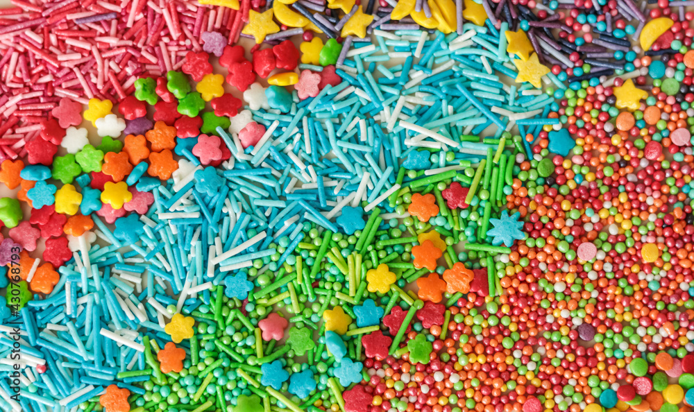 Fototapeta premium Abstract background of multicolored sugar sprinkles of different shapes for decorating glazed pastries