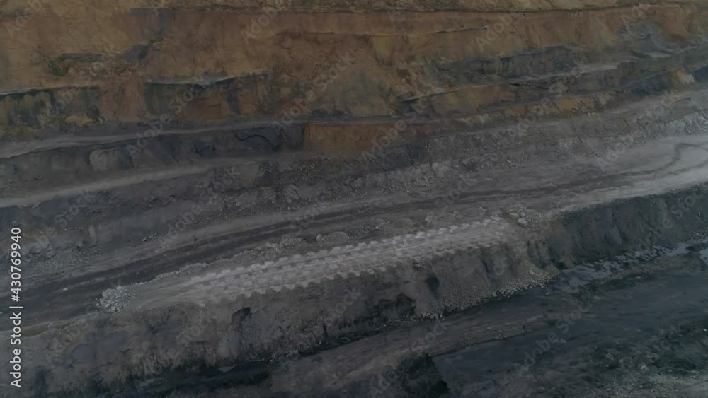 Aerial view panorama of coal quarry. In the center of the shot is a site with Openings for explosives. There are explosives next to the wells. Preparation of an explosion at the quarry site.
