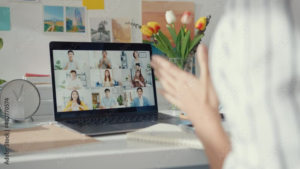 Young asia female employee listen leader on video call with diverse multiracial colleagues on online with laptop at home. Distance learning. Girl student learn online at house, Online meeting concept.