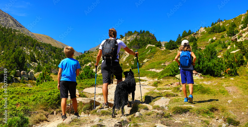 Fototapeta premium family hiking in nature- father with kids travel