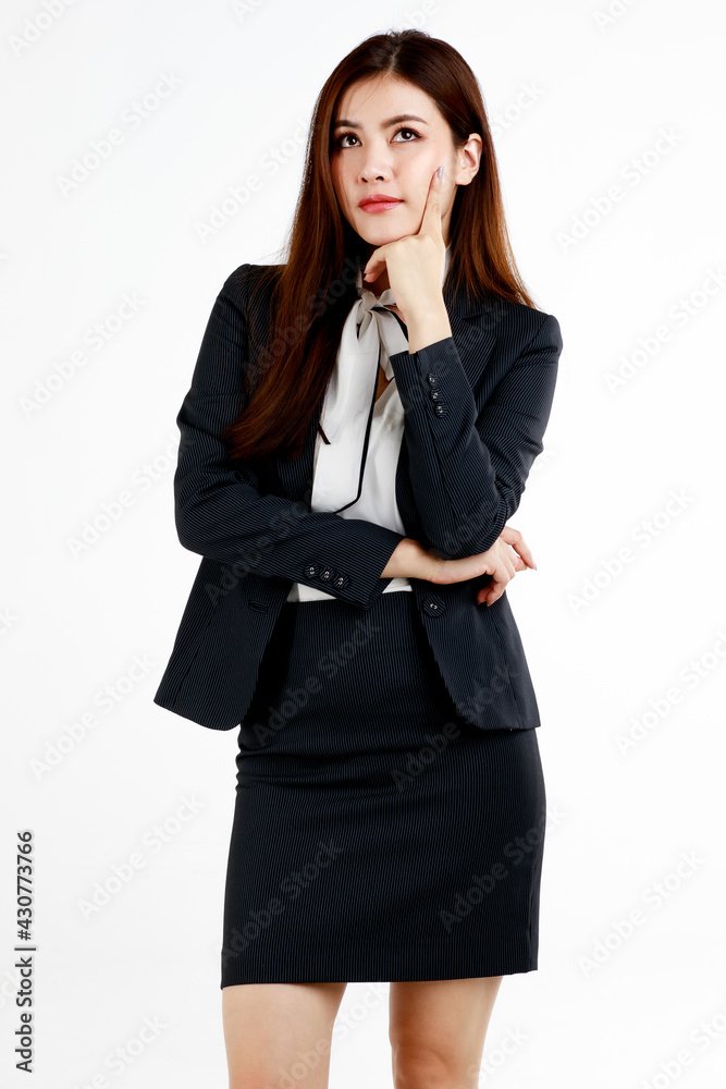 Young and cute businesswoman pose in thinking gesture by using finger touch cheek and look high above Young and cute businesswoman pose in thinking gesture by using finger touch cheek and look high above
