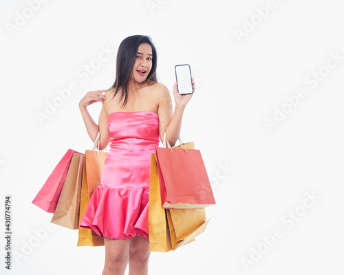 Woman with shopping bags and smartphone © jittima