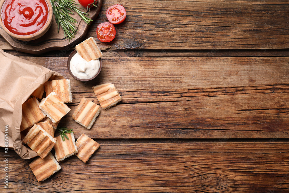 Delicious pita chips on wooden table, flat lay. Space for text Delicious pita chips on wooden table, flat lay. Space for text