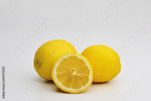 Ripe full yellow lemon. Lemon isolated on white background. Lemon, Citrus limon. Fresh organic yellow lemon lime fruit with slices and green leaves isolated on white background . 
