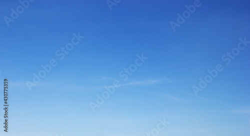 Blue sky background and white clouds soft focus, and copy space horizontal shape