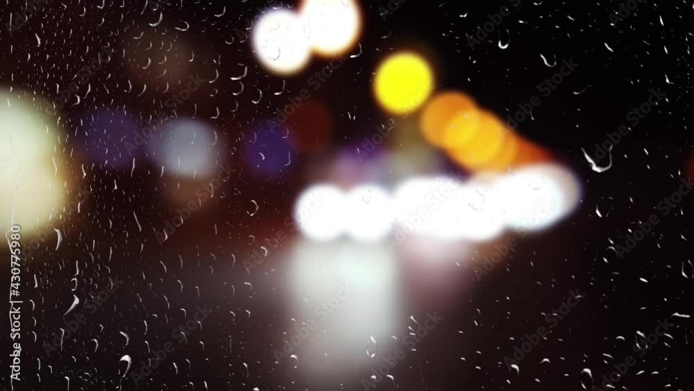 Lights of car headlights during the rain. View from the window. Lights of car headlights during the rain. View from the window.