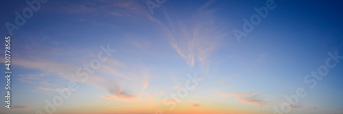 Beautiful sky painted by the sun leaving bright golden shades.Dense clouds in twilight sky in winter evening.Image of cloud sky on evening time.Evening sky scene with golden light from the setting sun