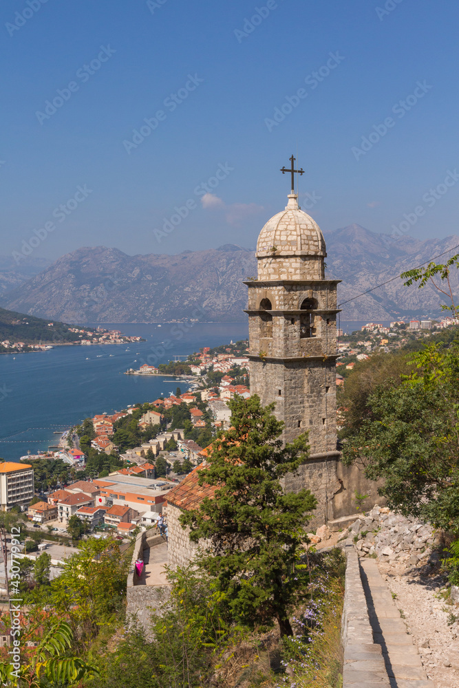 Wonderful view of the bell tower of the Church of Our Lady of Remedy standing on a hill in the town of Kotor. Montenegro 