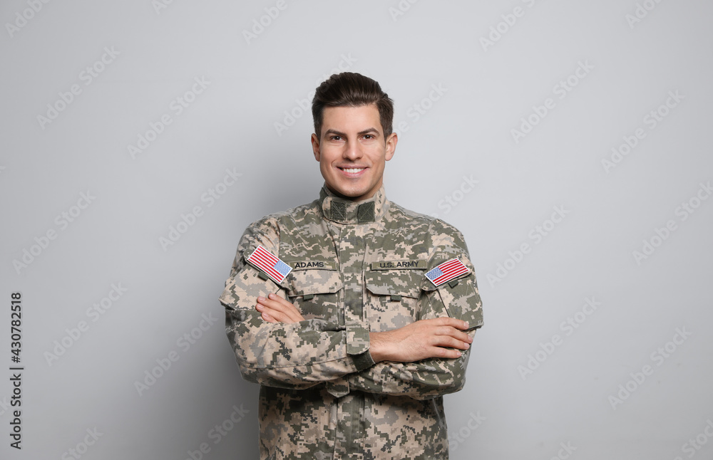 Portrait of happy cadet on light grey background Portrait of happy cadet on light grey background