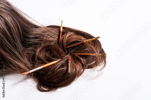 Hair rests on a white background with tassels instead of hairpins