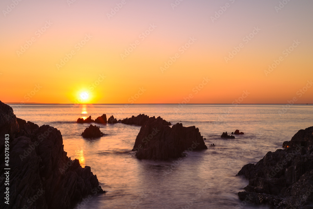 Beautiful calm sea and sunset scenery on the ocean as light reflects on the water
