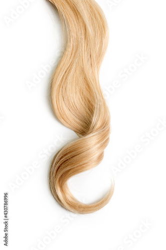 Curly blonde hair isolated on white background. Beautiful healthy long blond hair lock, haircut, hairstyle. Dyed hair or coloring, hair extension, cure, treatment concept. photo