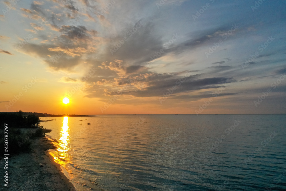 Beautiful orange sunset over the water. The Gulf of Finland. Coastal area Aerial view Coastline Beautiful orange sunset over the water. The Gulf of Finland. Coastal area Aerial view Coastline
