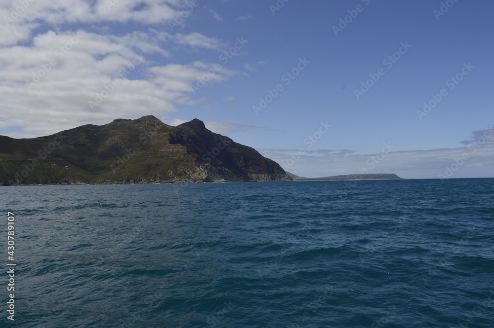 Landscape with sea and blue sky with mountain in the background