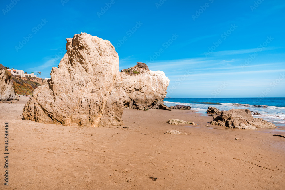 Matador beach and beautiful landscape with rocks and ocean against blue sky, California