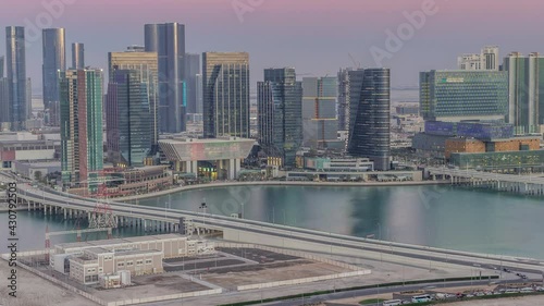 Aerial skyline of Abu Dhabi city centre from above day to night timelapse photo