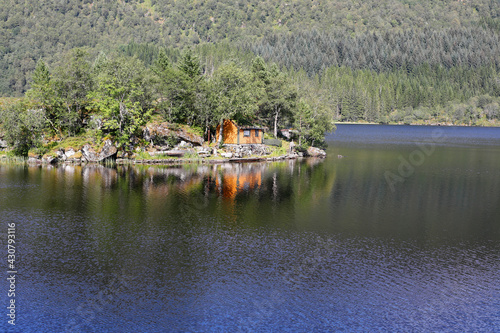 Nordic blue lake and island in a forest, silence and serenity
