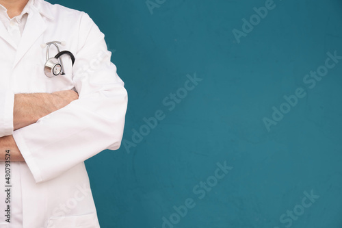 doctor, stethoscope in his coat pocket and crossed his arms in front of him