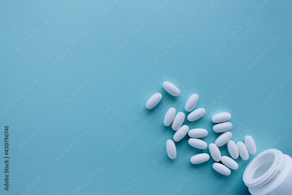 white pills on a blue background white pills on a blue background