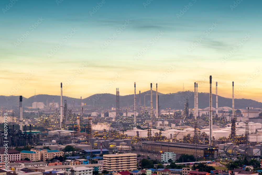 Oil refinery with tube and oil tank along twilight sky at Si Racha District, Rayong