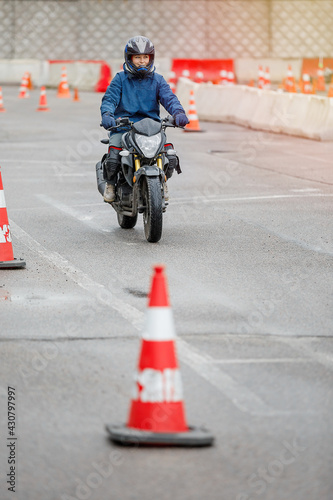 motorcycle driving school. a woman learns to drive before obtaining a driving license. 