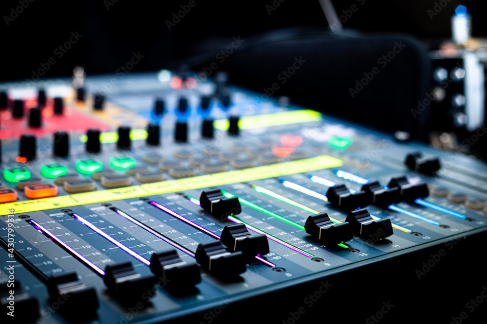 Sliders and buttons on Audio Mixing Desk at live event. Sliders and buttons on Audio Mixing Desk at live event.