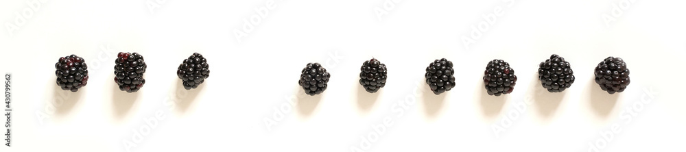 Nine blackberries on an isolated white background. Social distance concept. Nine blackberries on an isolated white background. Social distance concept.