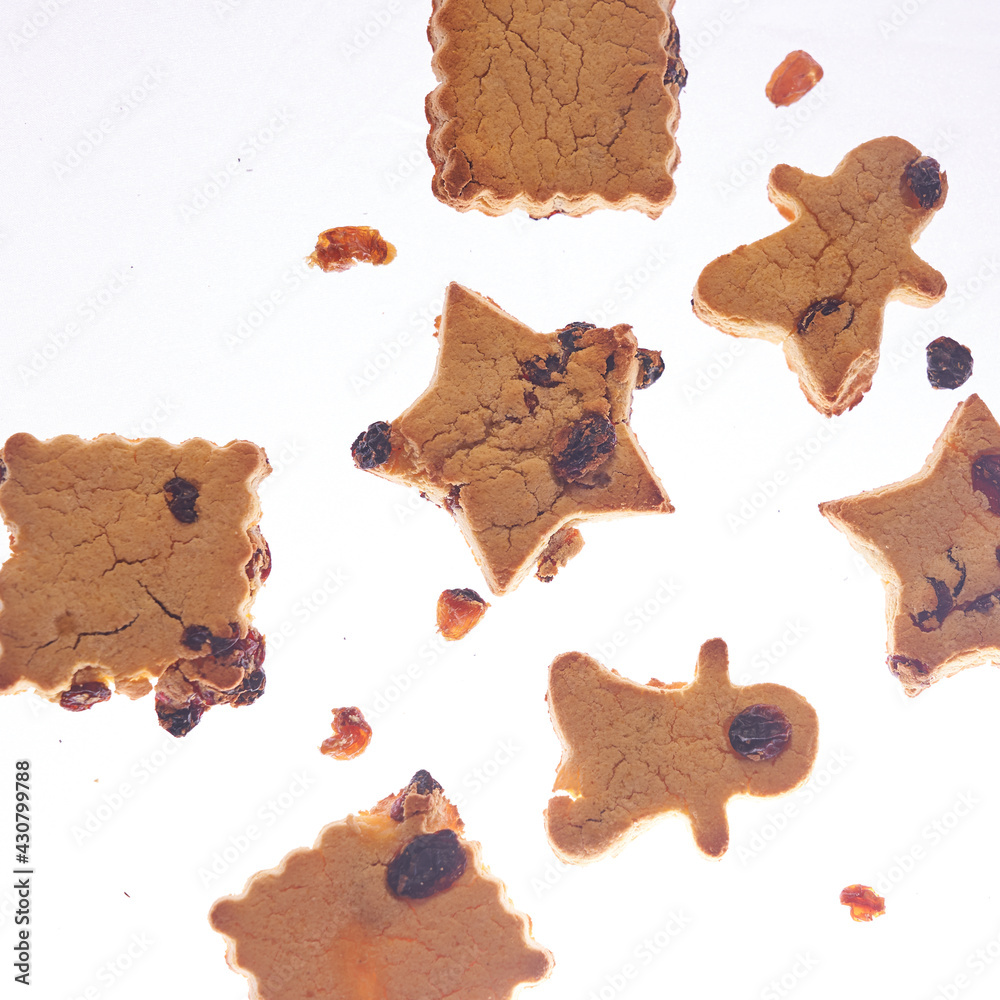 Cookies in different shapes, gluten-free, lactose-free, healthy dessert with dark chocolate and raisins on an isolated white background, levitation
