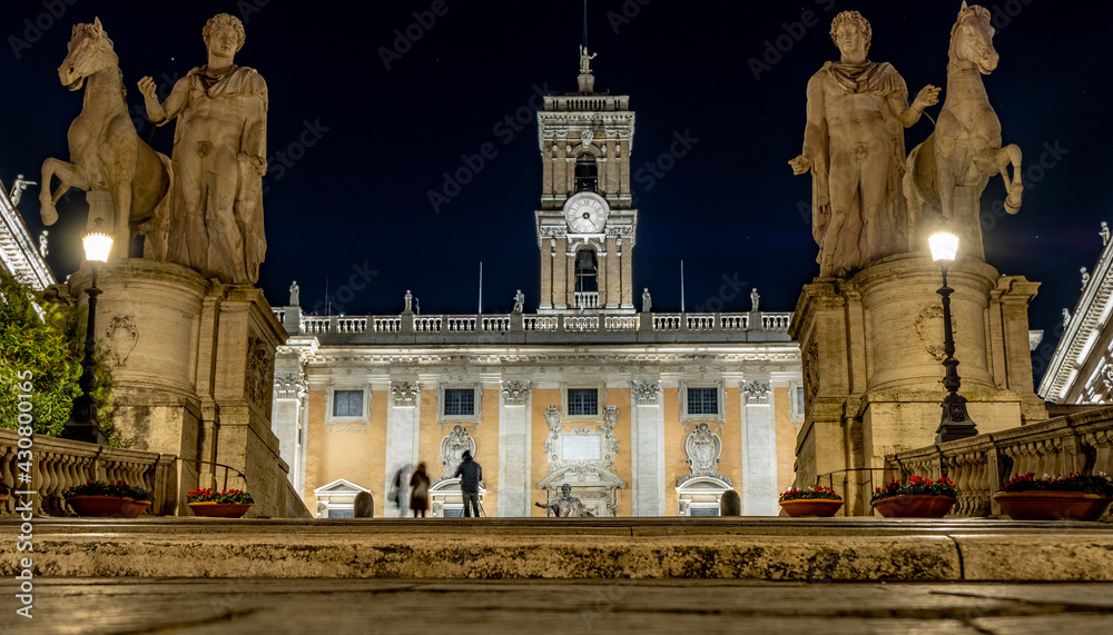 Long exposure shot of people taking photos in front of the Campidoglio, a hilltop square with museums designed by Michelangelo.