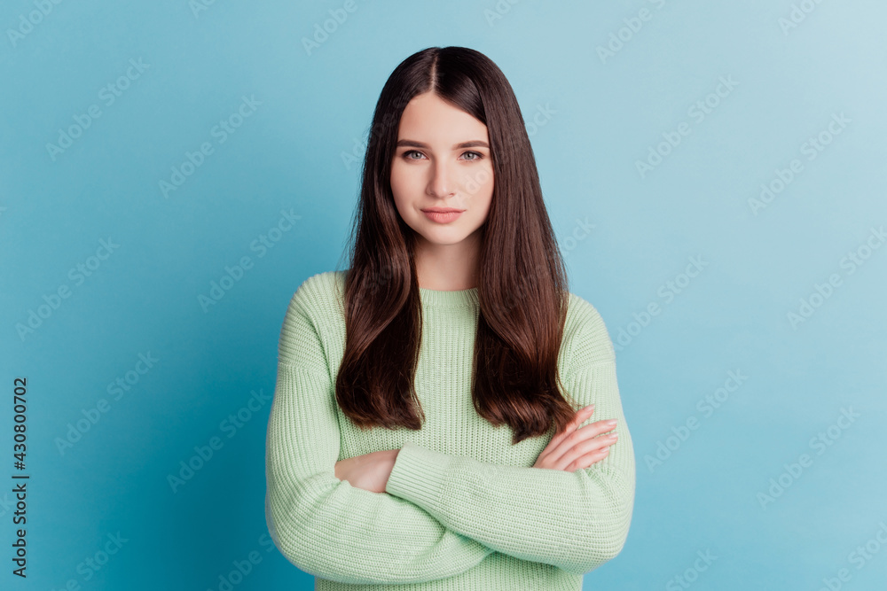 Portrait of confident cool woman crossed hands isolated on turquoise background Portrait of confident cool woman crossed hands isolated on turquoise background