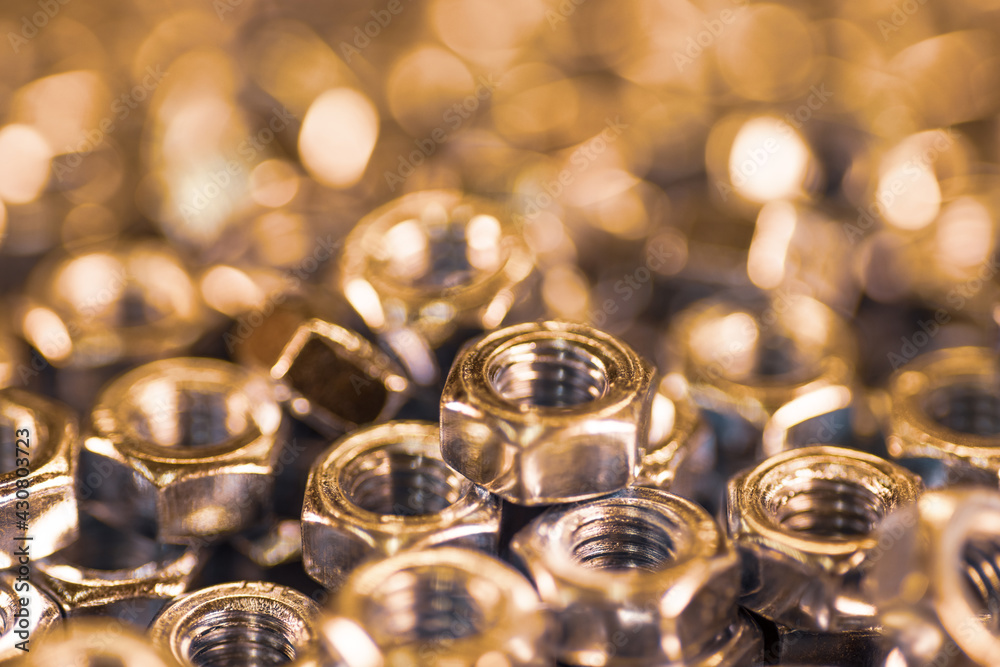 Metal chrome nuts in a chaotic order industrial background Metal chrome nuts in a chaotic order industrial background