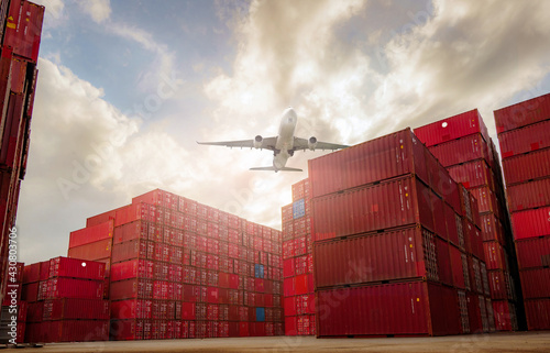 Airplane flying above container logistic. Container crisis. Freight transportation. Logistic industry. Container ship for export logistics. Container at the harbor for truck transport. Air transport. photo