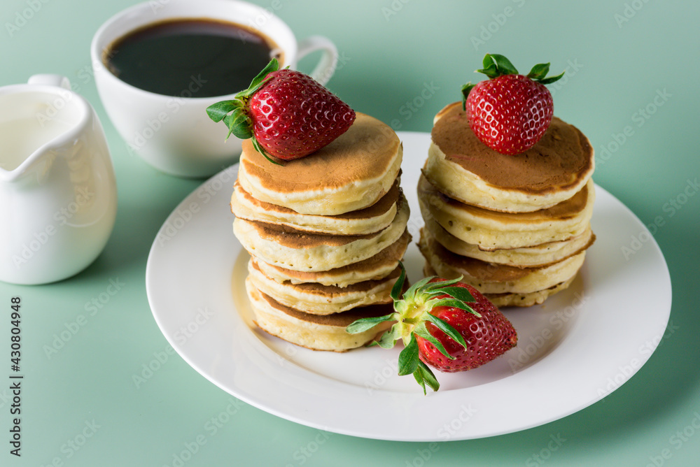 Freshly Baked Homemade Mini Pancakes on a Plate Fresh Berry Tasty Breakfast Green Background Horizontal