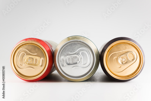 three metal cold cans with beer