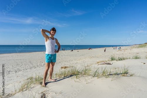 Athletic build. Young man on the sea beach. Young man resting on the sea. © SeagullNady