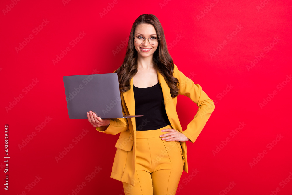 Fototapeta premium Photo of cute shiny young woman wear yellow jacket spectacles typing modern gadget smiling isolated red color background