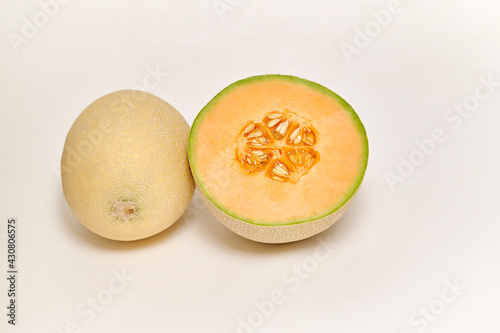 Canvas Print Whole and sliced Japanese melon, honey melon or Cantaloupe (Cucumis melo) on a w