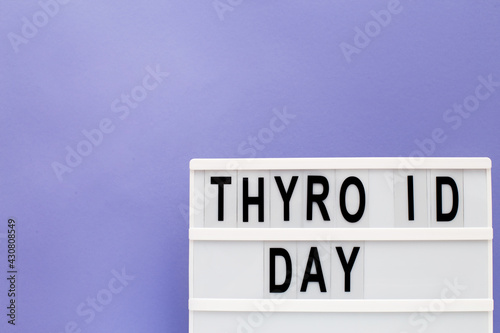 inscription international thyroid day on purple background. copy space