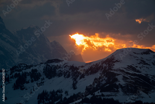 breathaking sunrise on the mountains with fire on the sky and beautiful view to the alps photo